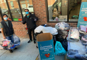 NimNim's COO offering clothes to an East Boston resident